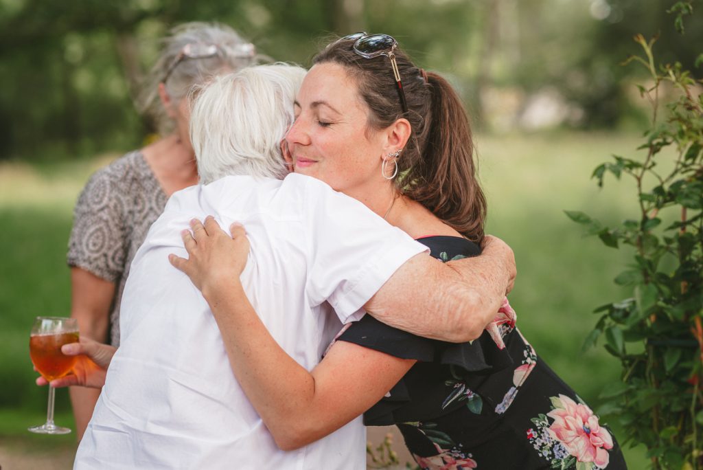 grandmother and granddaughter hug at a wedding