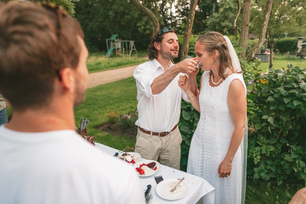 a bride and a groom and a quaich ceremony at a DIY garden wedding